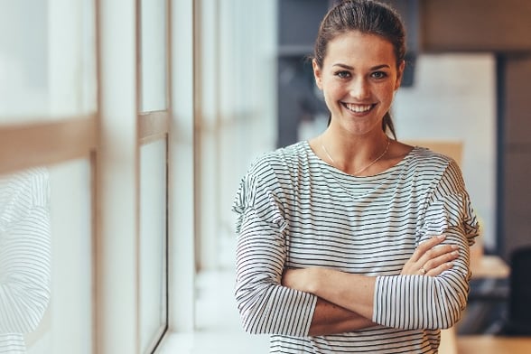 business casual woman crossing her arms and smiling