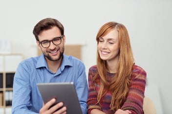two employees looking at ipad