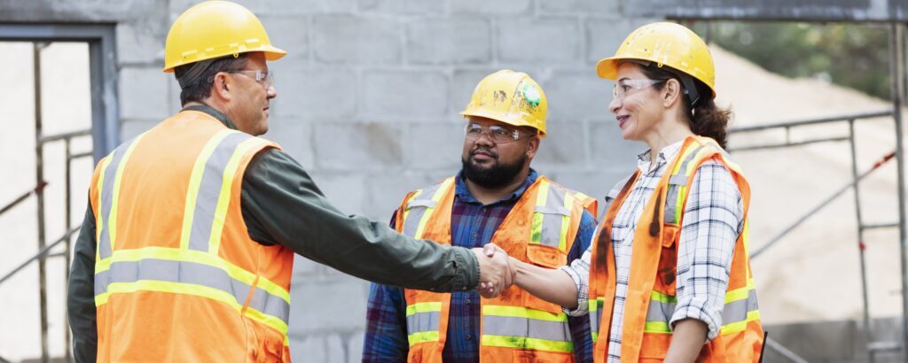 Construction workers shaking hands