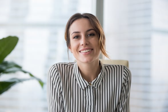 Woman in Striped Shirt Looking at Camera