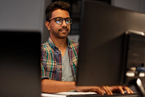 Young man in plaid shirt on computer-1-1