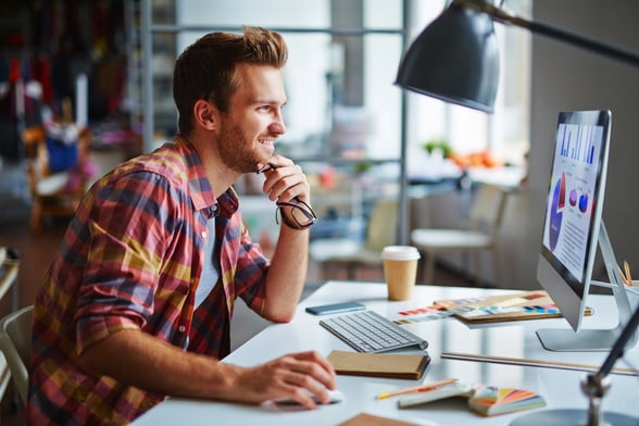 Young man in plaid shirt on computer