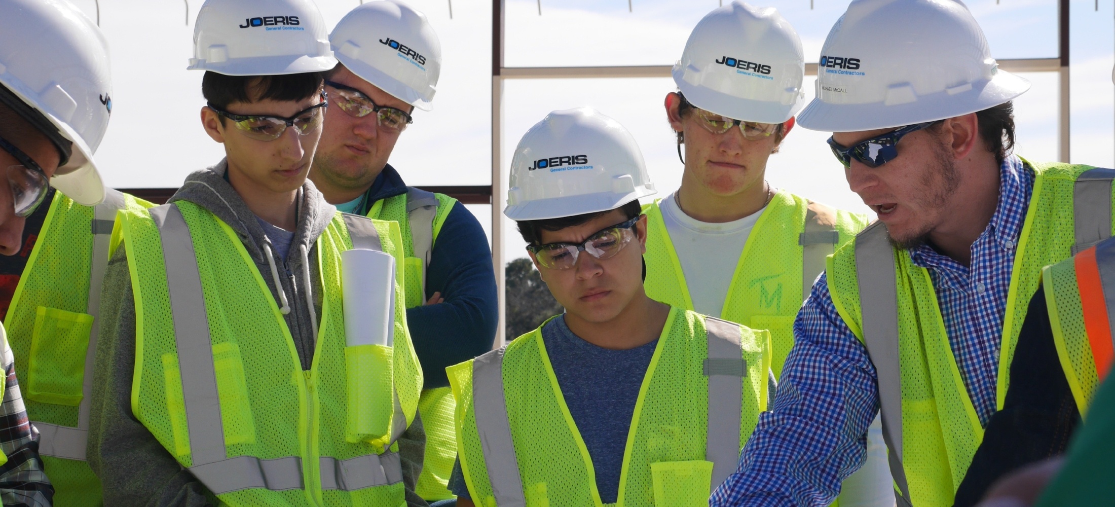 Joeris employees reviewing construction schematics at a job site.